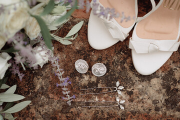 Bride's accessories with shoes, earings and lavander bouquet