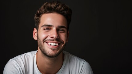 Obraz premium Handsome young smiling man black background