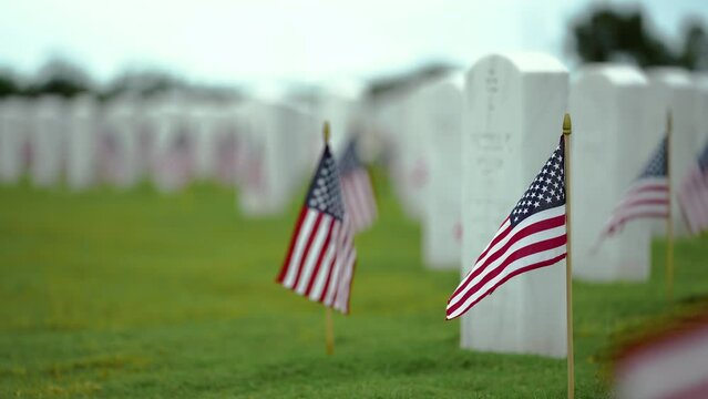 Sarasota National Cemetery with many white tombstones on green grass lawn. Memorial Day concept.