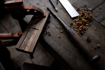 A carpenter carves wood



