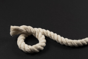 beige rope on dark background close up