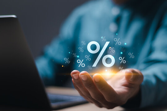 Interest rate finance and mortgage rates concept. Person holding virtual percentage icons. financial growth, interest rate increase, inflation, sale price and tax rise.