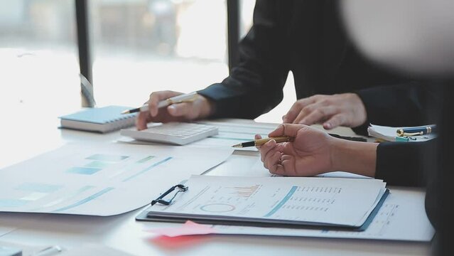 Close-up asia business people meeting plan analysis statistics brainstorm and header of team hold tablet pointing graph chart and employee take note. Finance strategy statistics success concept.