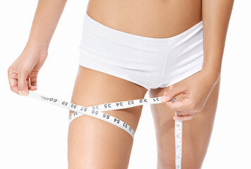 Woman, legs and tape measure for diet, weight loss or slim body in health and wellness on a white...