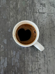 cup of coffee with heart shape on table