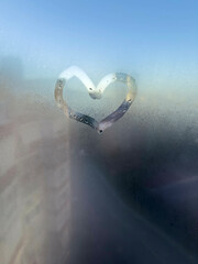 hand drawn heart shape on steamed glass