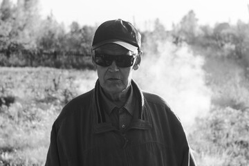 One modern senior Caucasian man wearing sun protection glasses portrait of male grandfather with beard, Black and white photo
