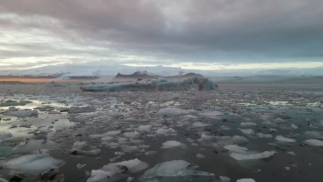 Spectacular drone aerial view of Iceland's largest glacier and glacial lake with huge floating glacier shards at sunset, Jokulsarlon and Vatnaj&ouml;kull gracier, Iceland.