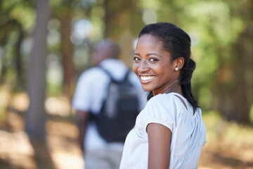 Portrait, smile and black woman hiking in the forest together with her husband for travel, freedom...