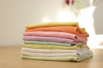 Stack of clean clothes on wooden table