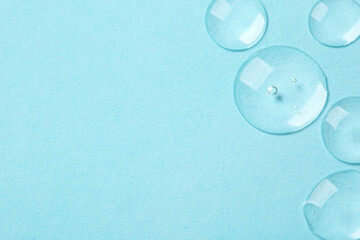 Samples of cosmetic serum on light blue background, flat lay. Space for text
