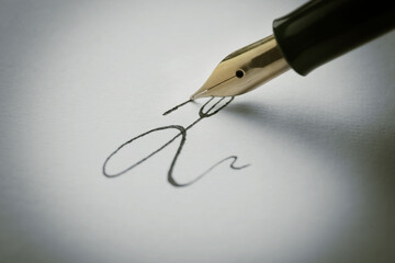 Fototapeta premium Signing on sheet of paper with fountain pen, closeup