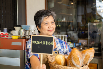 Asian elderly, senior, pensioner, female open cafe restaurant small business at home town after retirement, healthy strong 60s woman happy lifestyle wearing apron working as barista waitress worker