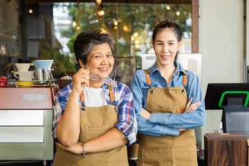 Asian elderly, senior, pensioner, female open cafe restaurant small business shop at home town after retirement, healthy strong 60s mother, and barista daughter working together bonding relationship