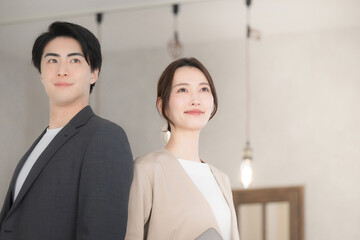 Close-up of business scene of men and women looking up, smiling and staring into the future
