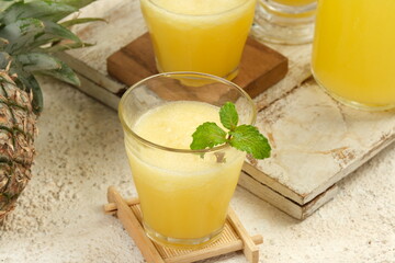 pineapple juice in glass on white table