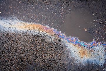 .Abstract background from motor oil, gas or petrol spilled on asphalt.