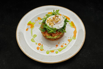 Salmon tartar with avocado, poached egg and arugula