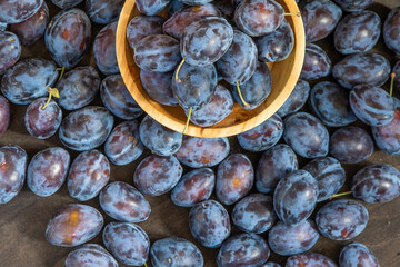 Plum variety Hungarian. Fruit harvest on the table in the kitchen. Autumn blue plum. Vitamin food bowl.