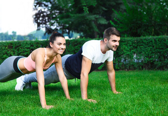 Young couple exercising and stretching muscles before sport activity