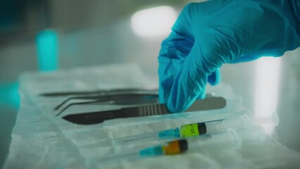 A doctor surgeon in protective gloves takes a surgical scalpel with his hand in the research room. Camera movement professional worker uses scalpel in surgery studying research data surgery - Powered by Adobe
