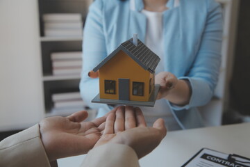 Real estate agent and customer signing contract to buy house, insurance or loan real estate.rent a...