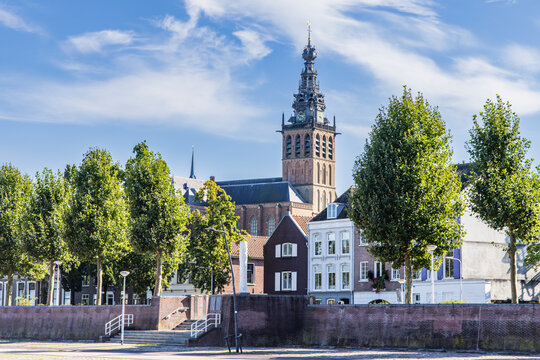 Cityscape of Nijmegen in The Netherlands with church from river quay called Waalkade along river Waal on a sunny autumn day