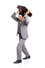 Angry, stress and business man with briefcase throw in studio frustrated on white background. Burnout, pressure and male entrepreneur with crisis, disaster or overwhelmed by deadline, mistake or fail