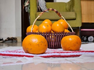 Resting on a rustic basket, the perfectly rounded orange gleams with vibrant color. Its smooth skin...