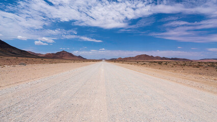 Mesmerising view of one of the endless straights while driving through the gravel roads inside Namibia
