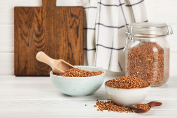 Raw buckwheat in a bowl on a textured background.Wheat grains, porridge, cereals, raw buckwheat in a plate. Healthy food. Porridge. Diet. Organic cerea. Space for text.Copy space.
