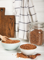 Raw buckwheat in a bowl on a textured background.Wheat grains, porridge, cereals, raw buckwheat in a plate. Healthy food. Porridge. Diet. Organic cerea. Space for text.Copy space.