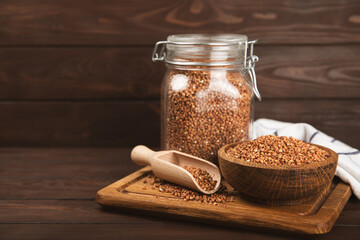 Raw buckwheat in a bowl on a textured background.Wheat grains, porridge, cereals, raw buckwheat in a plate. Healthy food. Porridge. Diet. Organic cerea. Space for text.Copy space.