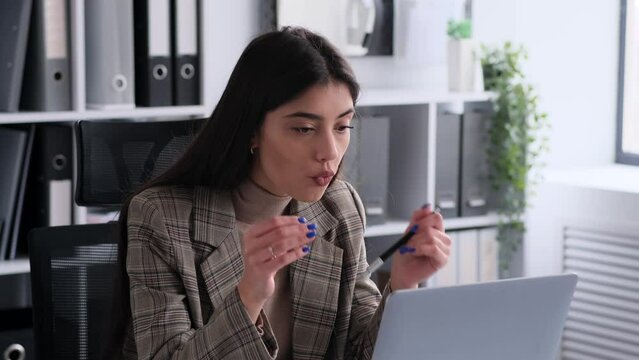 Expressing dissatisfaction, an businesswoman communicates disapproval during a video call in the office. This assertive image captures the no nonsense attitude and professional assertiveness.