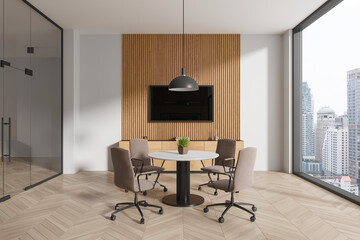 Modern glass office room interior with table and chairs, tv screen and window