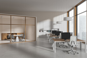 Stylish workspace interior with glass meeting area and workspace near window
