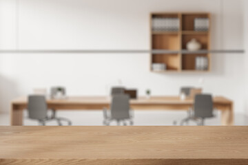 Wooden desk on blurred background of meeting room interior. Mockup