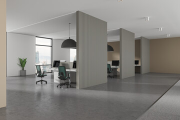 Stylish coworking interior with armchairs, pc computers and partition, window