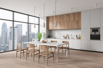 Stylish home kitchen interior with eating and cooking zone, panoramic window