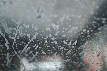 Soap suds on the glass. View from Inside car, automatic car wash. Background image and texture.