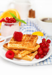 Delicious breakfast with fresh coffee, fresh waffles and fruits