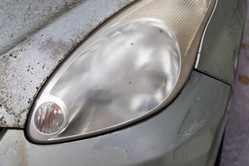 Hazy opaque foggy front head lamp of car reduces light pass-through and driving visibility © ThamKC