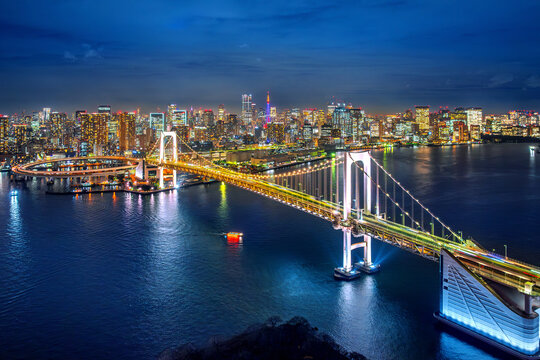 Aerial view of Tokyo cityscape and rainbow bridge at night, Japan.