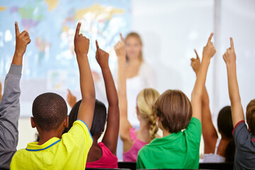 Back of students, classroom and raise hands for questions, education or learning with geography...