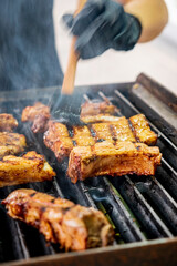 chef with brush cooking ribs