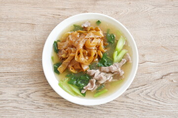 fried large noodle with slice beef meat and Chinese kale dressing gravy sauce on plate 