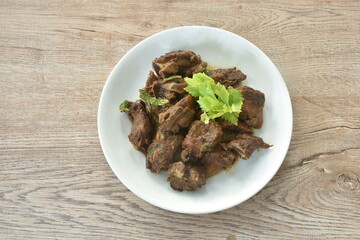steamed pork bone with black sweet soy sauce topping celery on plate