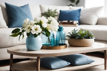 Coastal interior home design of modern living room with flower vase on the table and white sofa with blue pillows