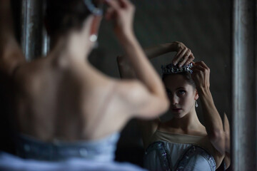 Ballerina adjusts the tiara on her head.