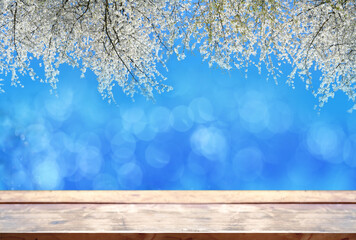 Beautiful floral spring abstract nature background, white blooming branches with wooden table on...